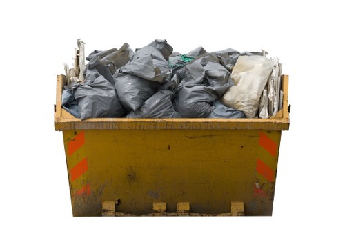 Construction debris and workers managing waste in Merton