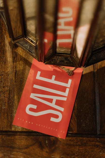 A close-up image features a vibrant green paper shopping bag with a matching satin ribbon handle positioned on a black textured surface. Below the bag, large, colorful foam letters spell out the word 